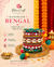 A decorative stack of colorful woven thread wraps with cowrie shells and pom-poms, displayed on a gold tray beside lit candles and marigold garlands. The brand name BhaviCraft appears prominently at the top, with marketing text reading 'Handmade Bengal' and product features on a cream background.